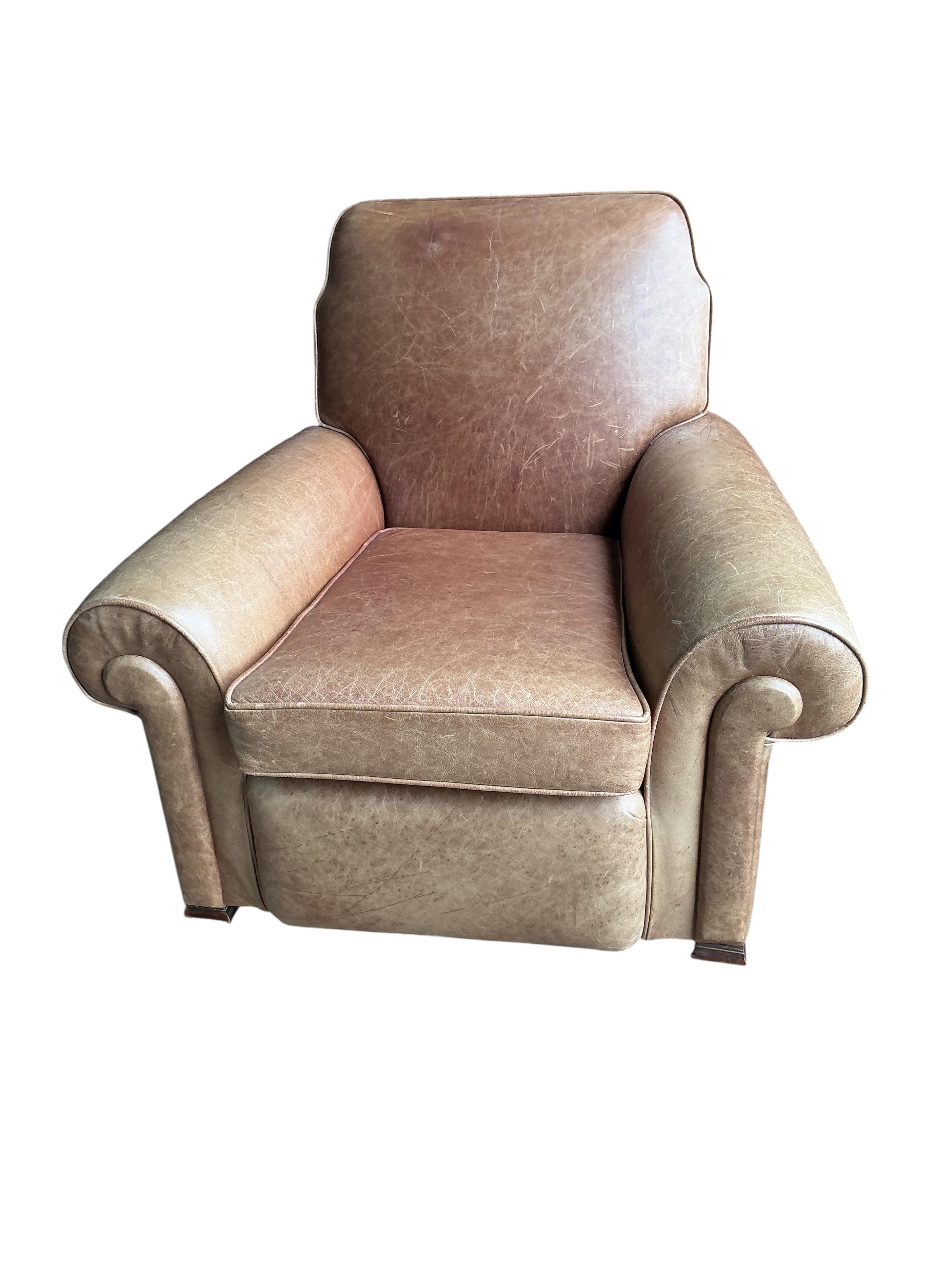 A pair of early 20th century tan leather club chairs, width 94cm, depth 78cm, height 80cm